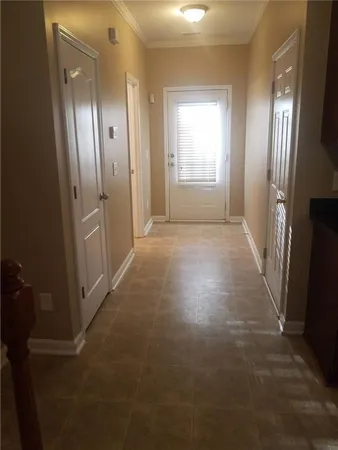 an empty room with windows and wooden floor
