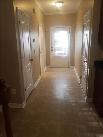 an empty room with windows and wooden floor