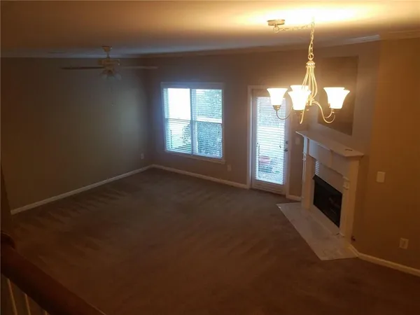 a view of empty room with fireplace and fan