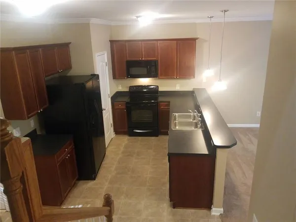 a kitchen with granite countertop a refrigerator and a stove