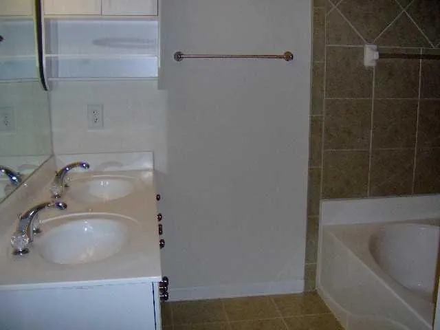 a view of a house with a backyard and wooden fence