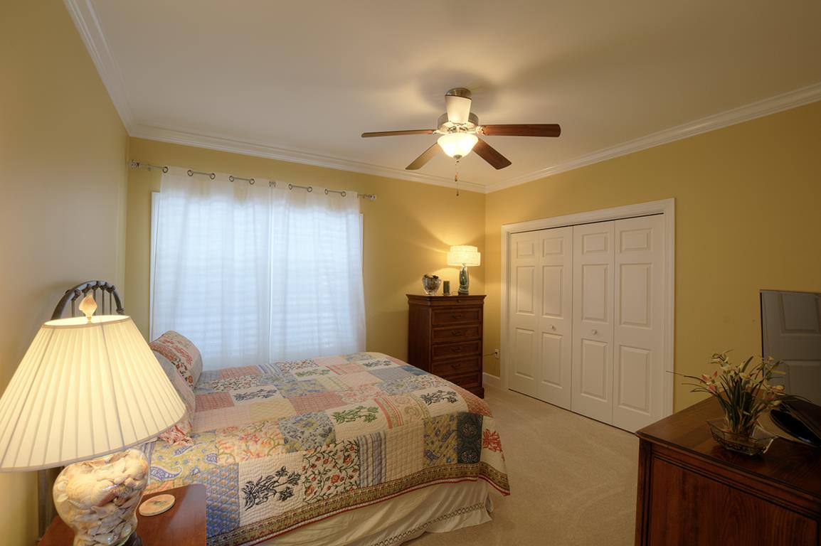 7100 Dale Ridge Road, Unit J3 Lancaster, TN 38569 - Photo 14 of 21 a bedroom with a bed and a chandelier