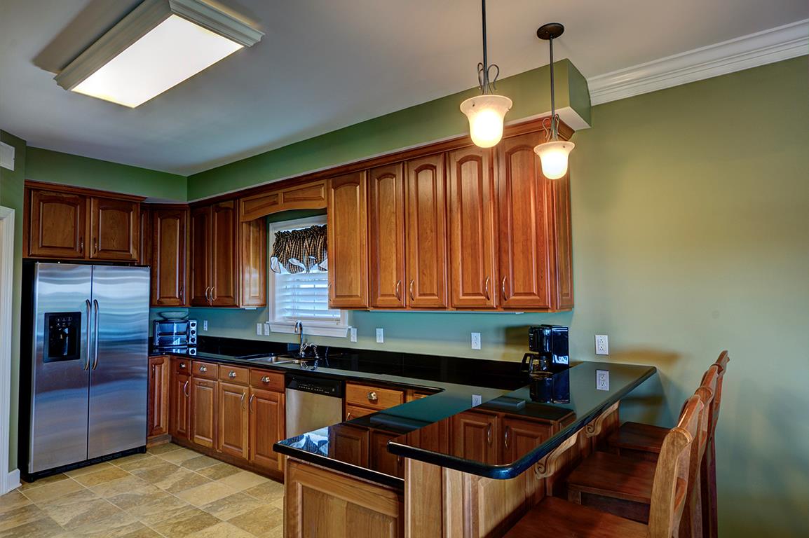7100 Dale Ridge Road, Unit J3 Lancaster, TN 38569 - Photo 5 of 21 a kitchen with stainless steel appliances granite countertop a stove a sink and a refrigerator