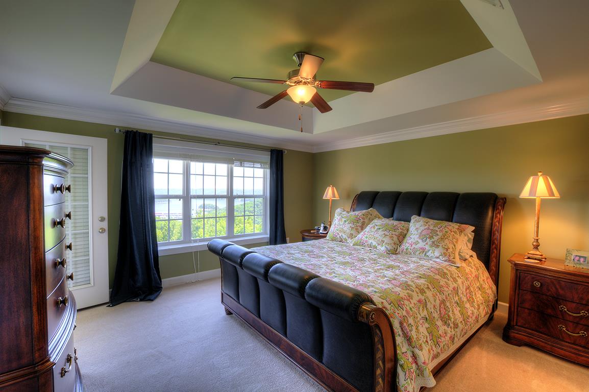 7100 Dale Ridge Road, Unit J3 Lancaster, TN 38569 - Photo 9 of 21 a bedroom with a bed and a chandelier