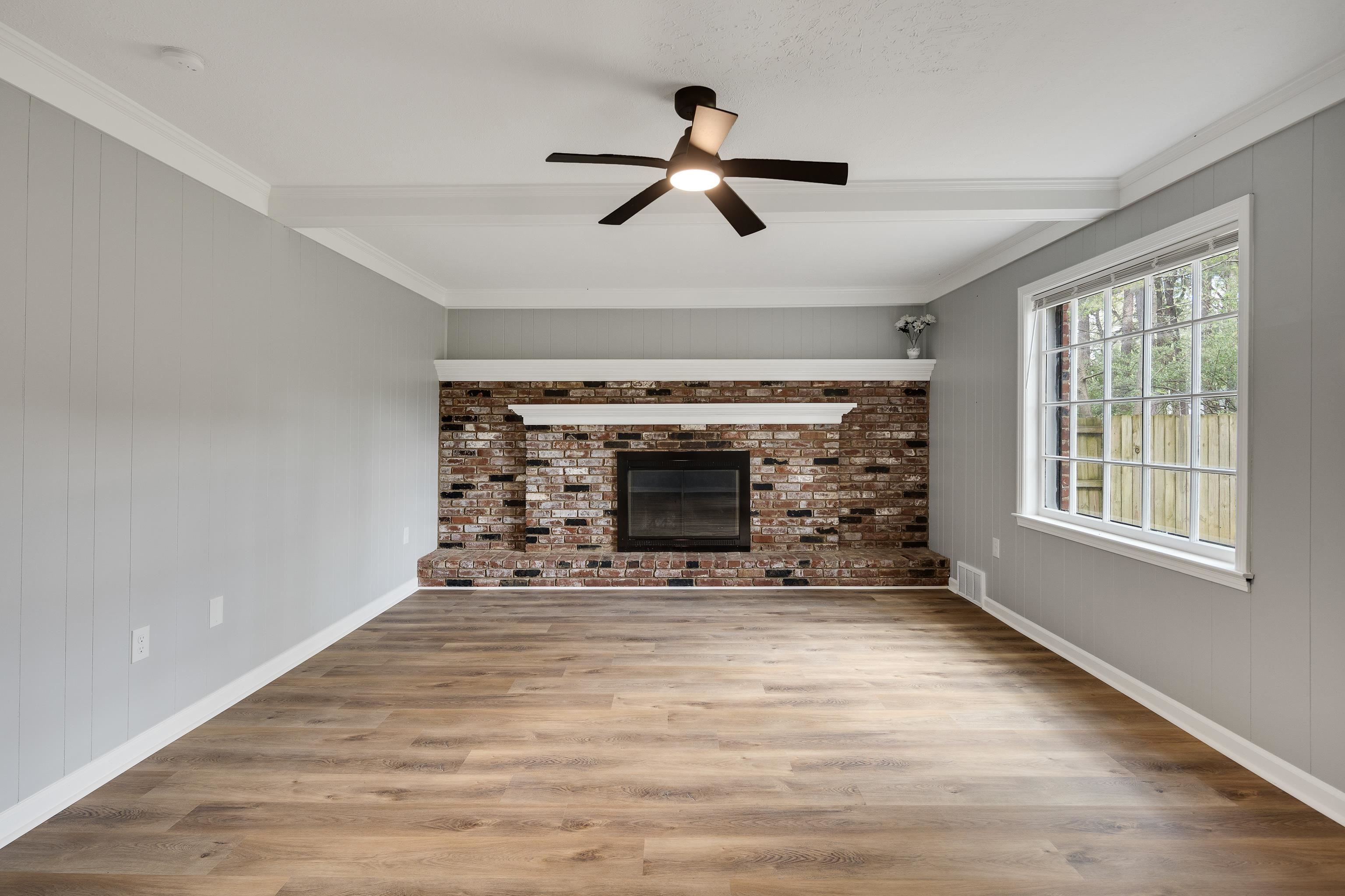 2096 Allenby Road Germantown, TN 38139 - Photo 12 of 40 a view of an empty room with a fireplace and a window