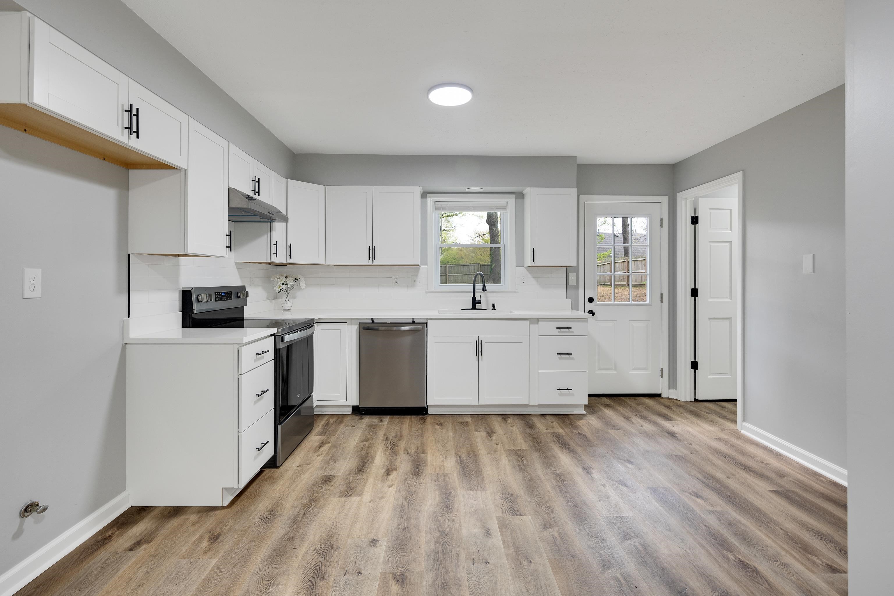 2096 Allenby Road Germantown, TN 38139 - Photo 16 of 40 a kitchen with stainless steel appliances white cabinets a sink a stove a refrigerator and white cabinets