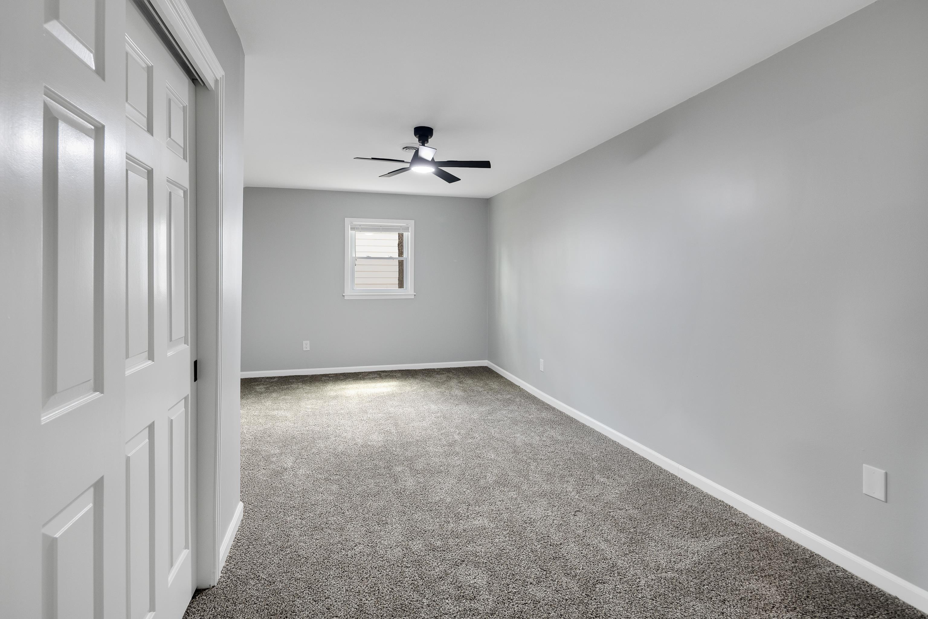 2096 Allenby Road Germantown, TN 38139 - Photo 23 of 40 an empty room with windows and chandelier fan