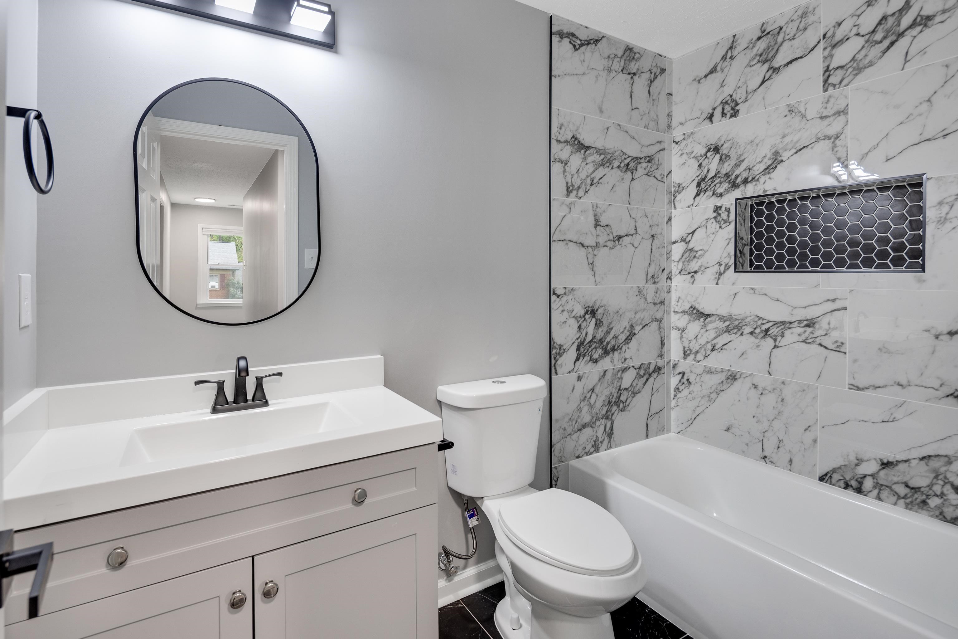 2096 Allenby Road Germantown, TN 38139 - Photo 26 of 40 a bathroom with a sink a toilet and a mirror