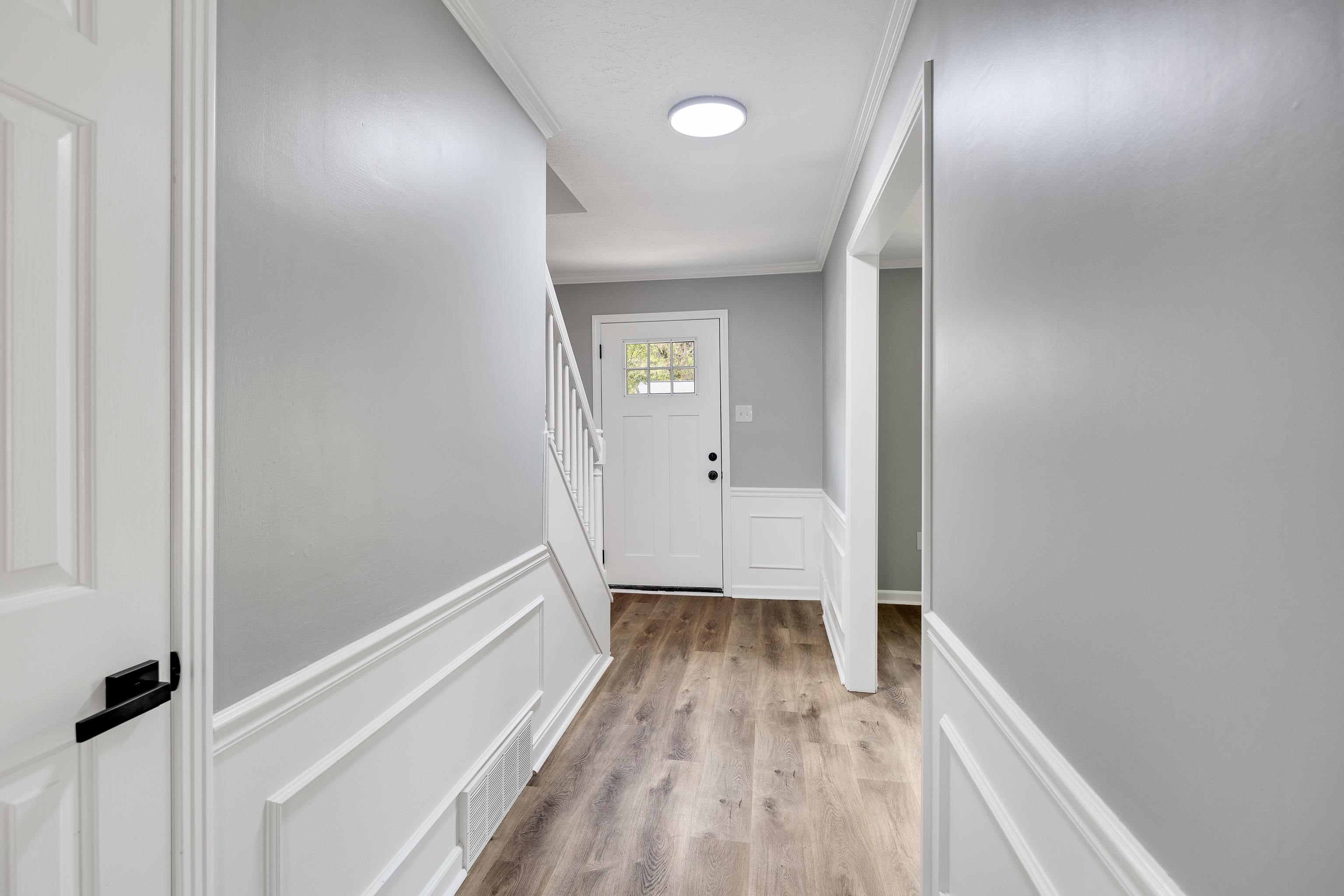 2096 Allenby Road Germantown, TN 38139 - Photo 6 of 40 a view of a hallway with wooden floor and a bathroom