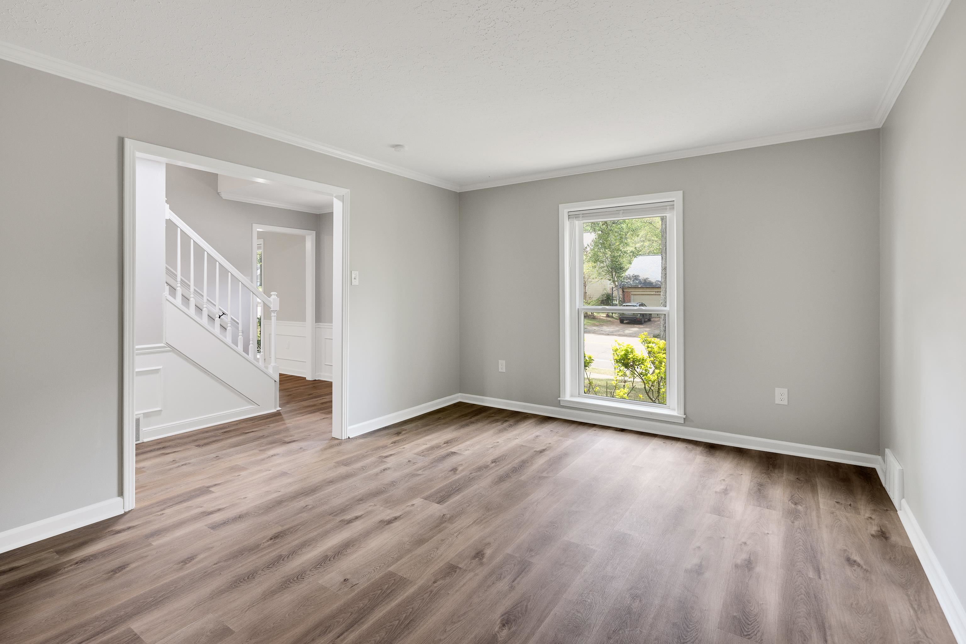 2096 Allenby Road Germantown, TN 38139 - Photo 8 of 40 a view of an empty room with wooden floor and a window