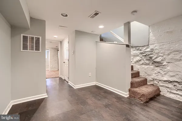 a view of a livingroom with wooden floor and kitchen space