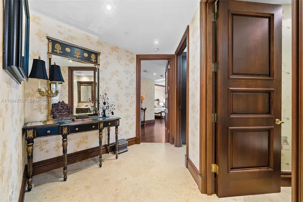 a hallway with wooden floor electronic appliances and furniture