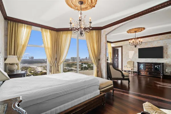 a bedroom with a bed and a chandelier