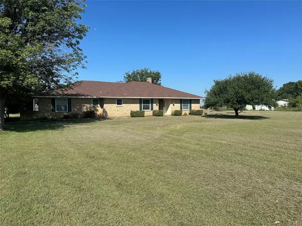 a view of a house with yard and sitting area