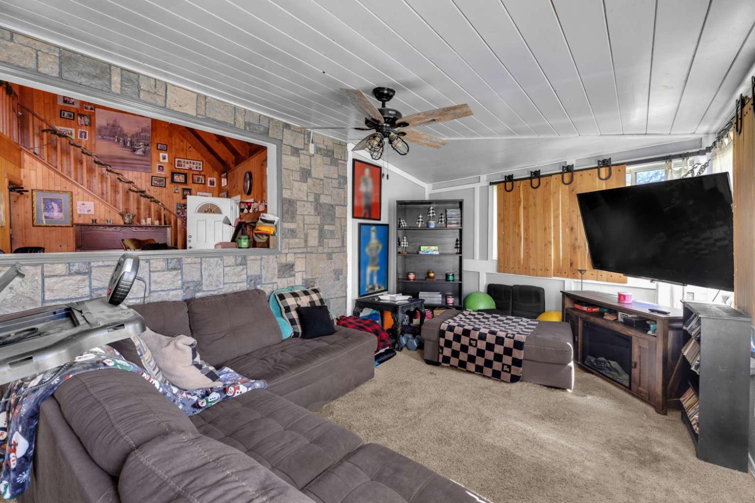 13489 Yorkshire Road Groveland, CA 95321 - Photo 6 of 35 a living room with furniture and a flat screen tv
