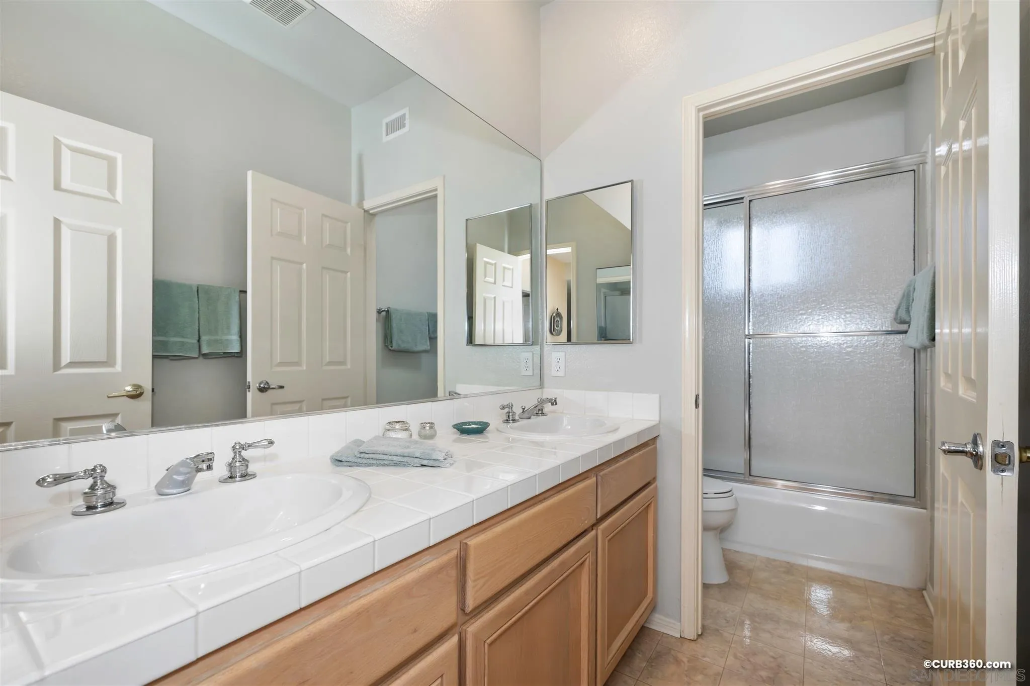 2520 Tompau Place Alpine, CA 91901 - Photo 20 of 41 a bathroom with a granite countertop sink mirror and double