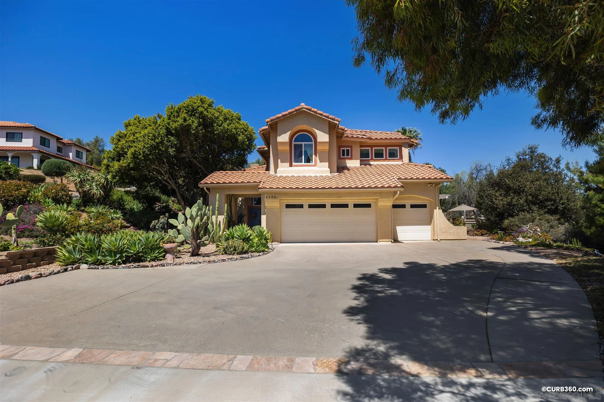 2520 Tompau Place Alpine, CA 91901 - Photo 3 of 41 a front view of a house with a yard and garage