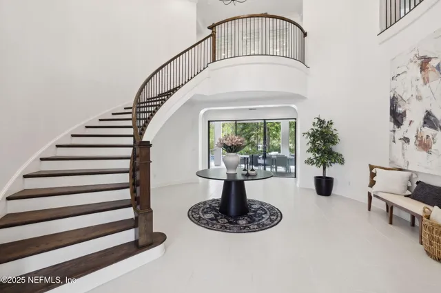 a bedroom with a bed next to a window