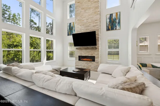 a outdoor space with lots of tables a large window and chairs