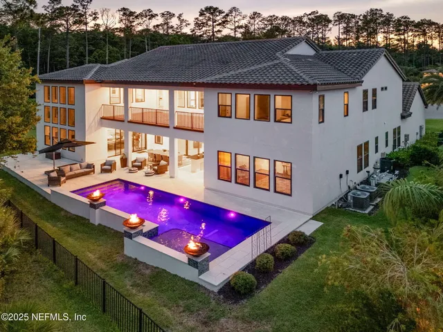 a view of swimming pool with a bench in front of house