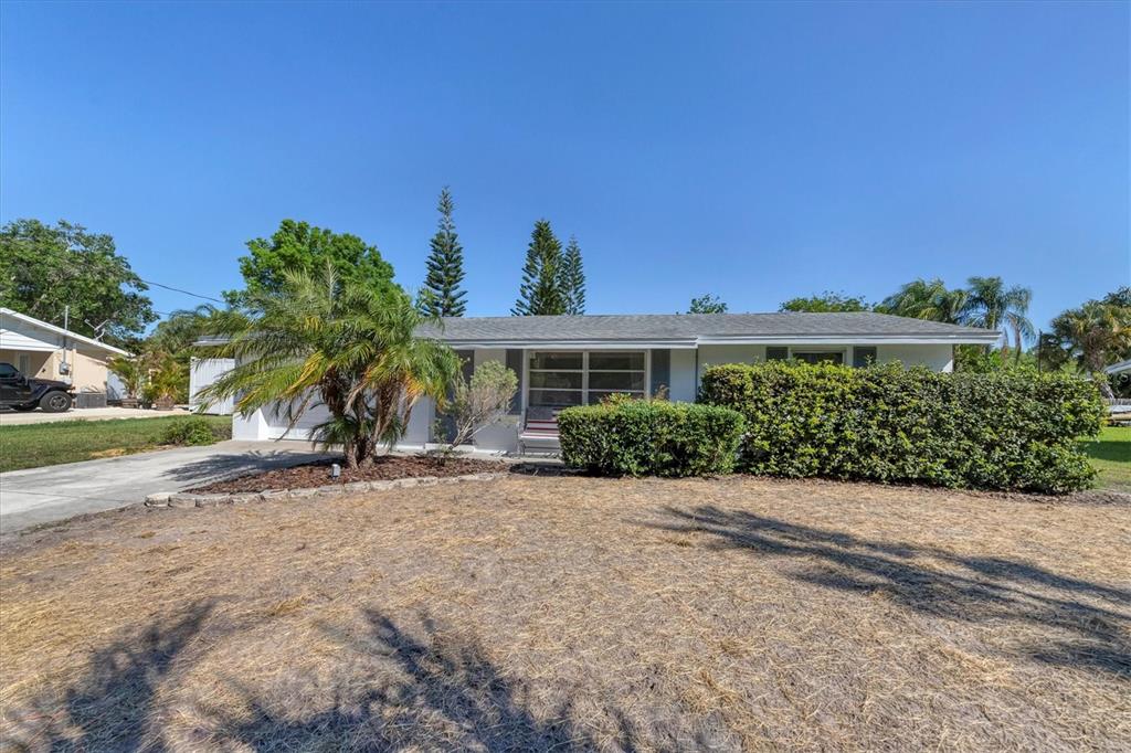2323 Doud Street Sarasota, FL 34231 - Photo 2 of 34 front view of a house with a yard