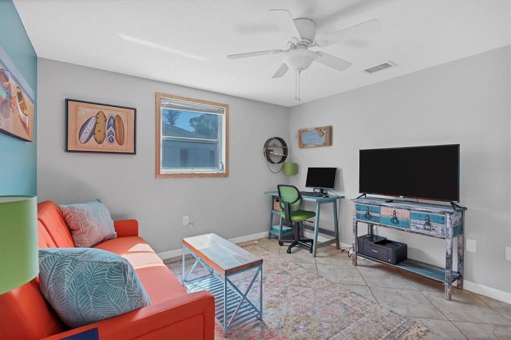 2323 Doud Street Sarasota, FL 34231 - Photo 21 of 34 a living room with furniture and a flat screen tv