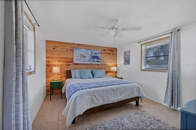 a bedroom with a bed and a painting on the wall