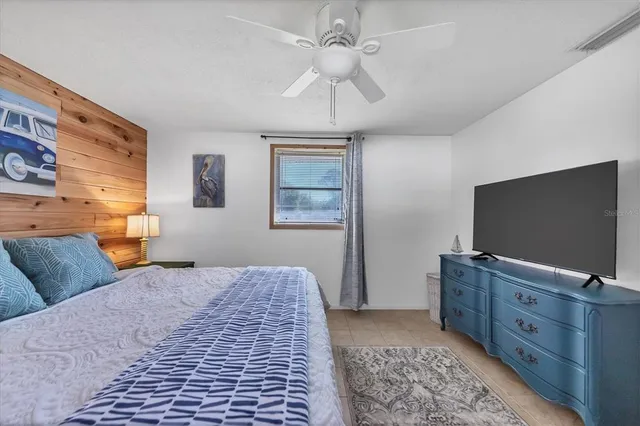 a bedroom with furniture and a flat screen tv