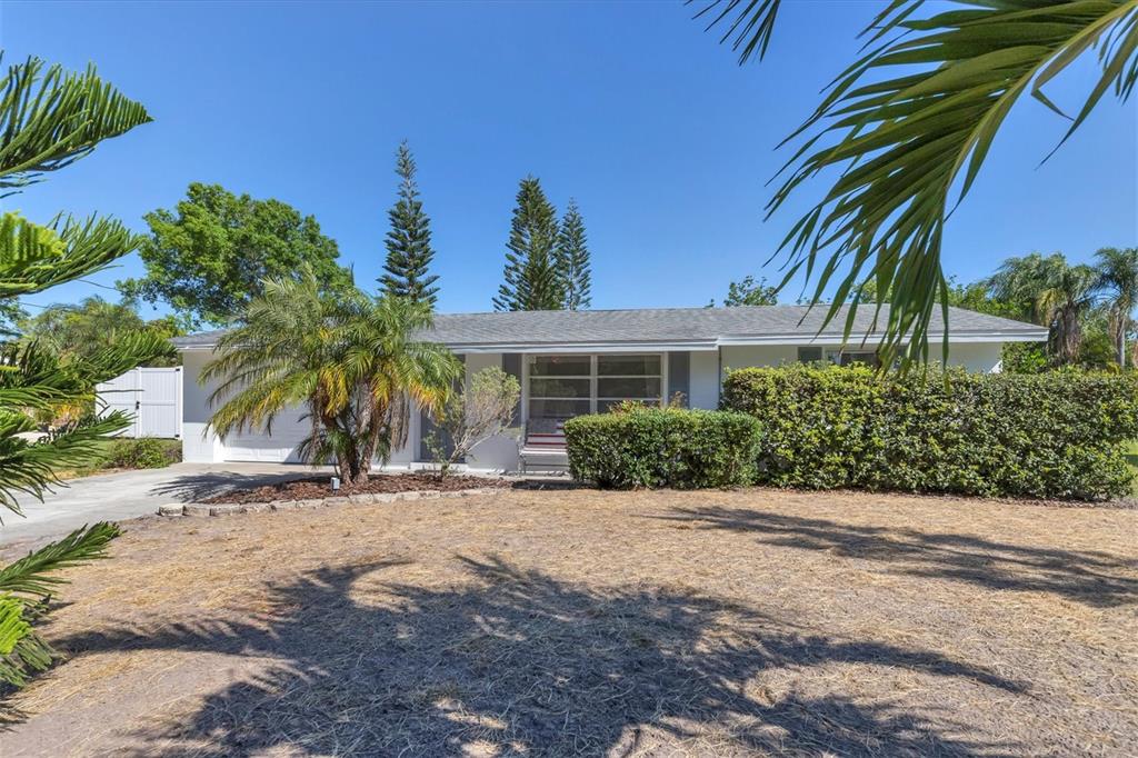 2323 Doud Street Sarasota, FL 34231 - Photo 3 of 34 a front view of a house with a yard
