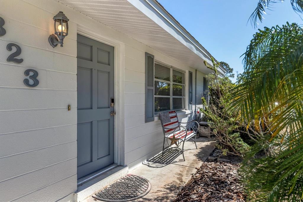 2323 Doud Street Sarasota, FL 34231 - Photo 4 of 34 a bench is sitting in front of a house