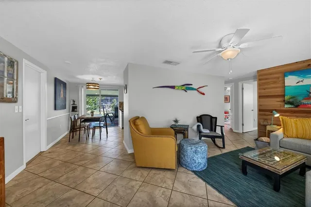 a living room with furniture and a dining table with garden view