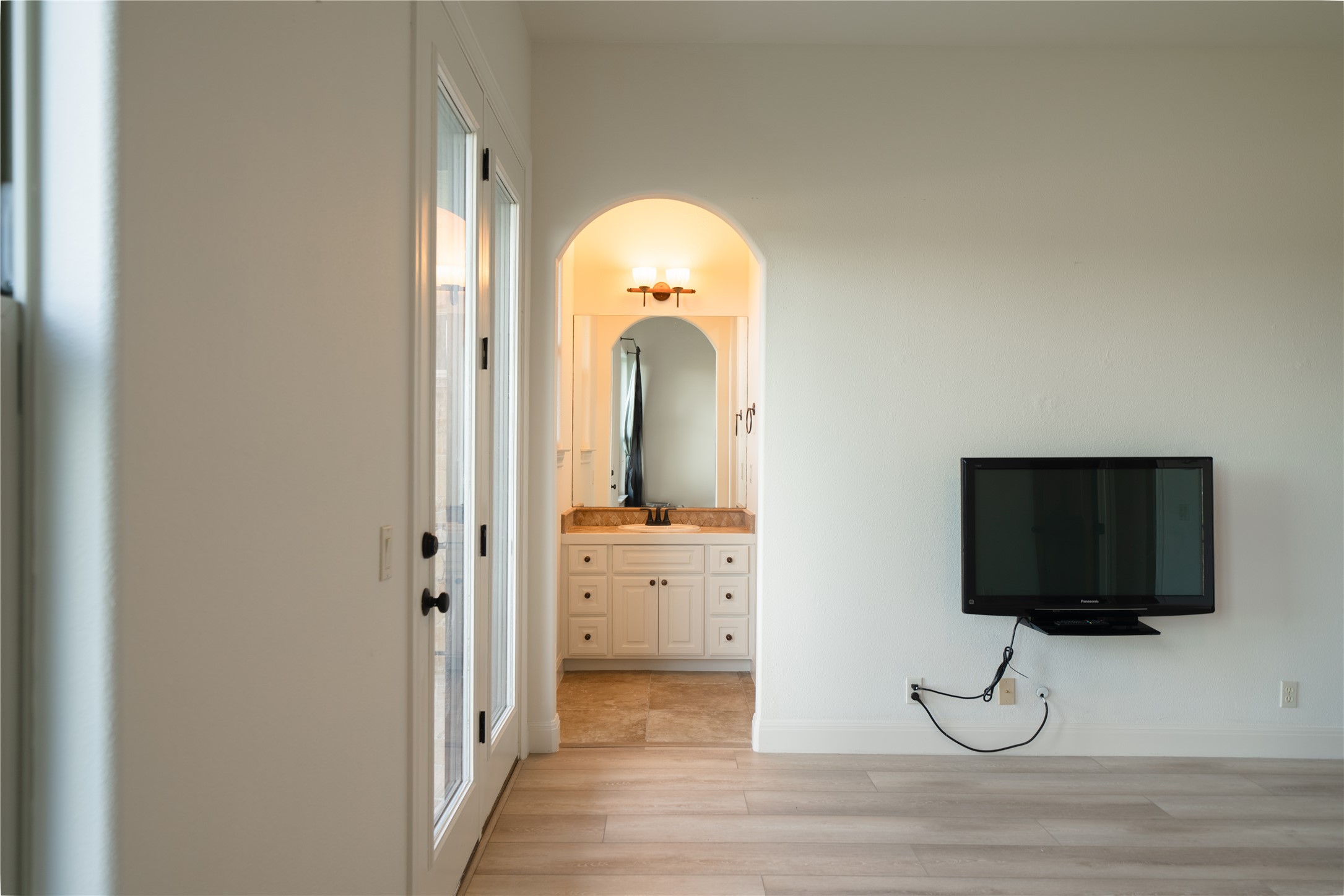 17545 West Reed Park Road, Unit 2 Jonestown, TX 78645 - Photo 27 of 39 a room with a flat screen tv and a floor to ceiling window