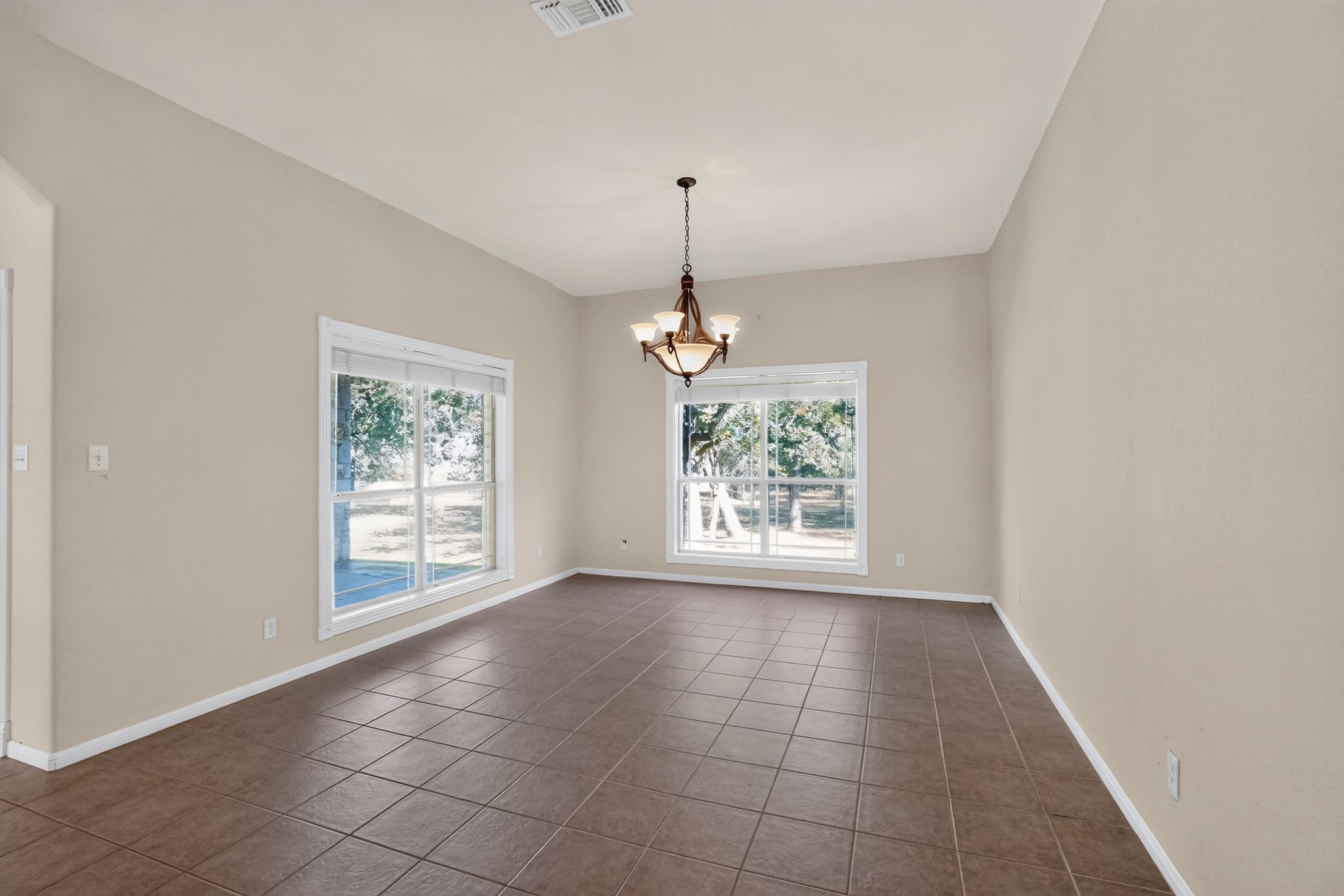 986 High Grove Road Cedar Creek, TX 78612 - Photo 20 of 30 Tiled flooring and large windows create a bright foundation in this versatile dining area.