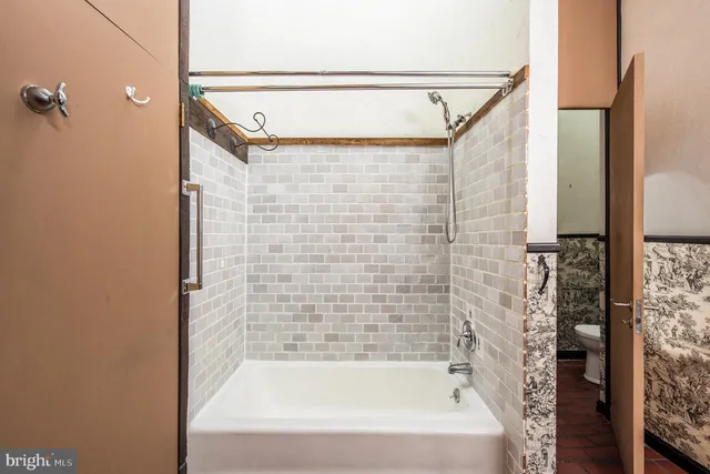 a bathroom with a bathtub and shower