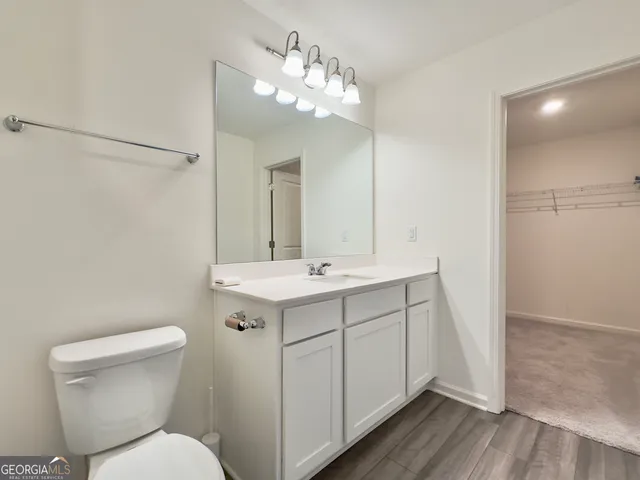 a bedroom with a bed and a chair