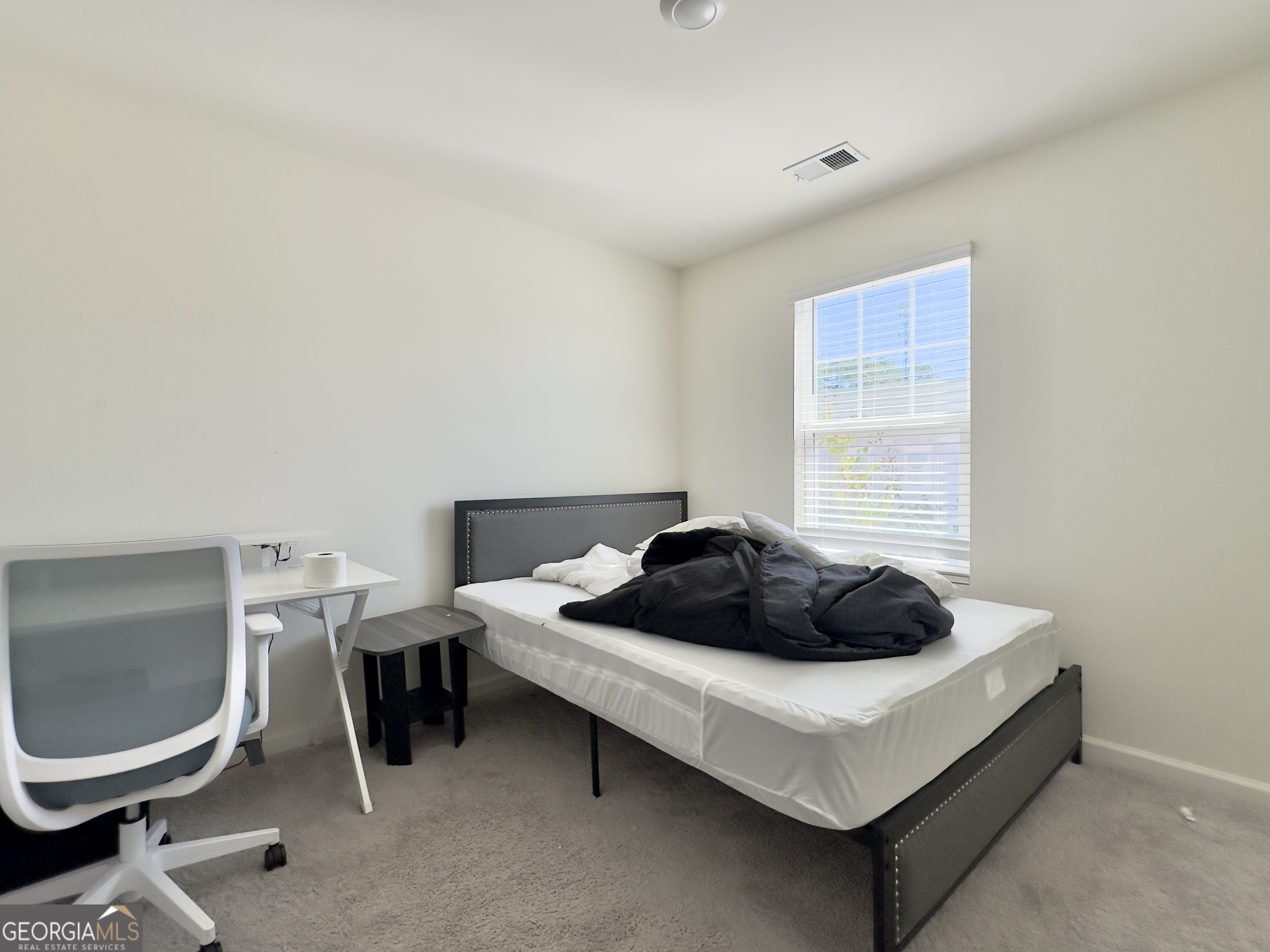 105 Ellicott Way Cartersville, GA 30120 - Photo 16 of 24 a bedroom with a bed and a chair