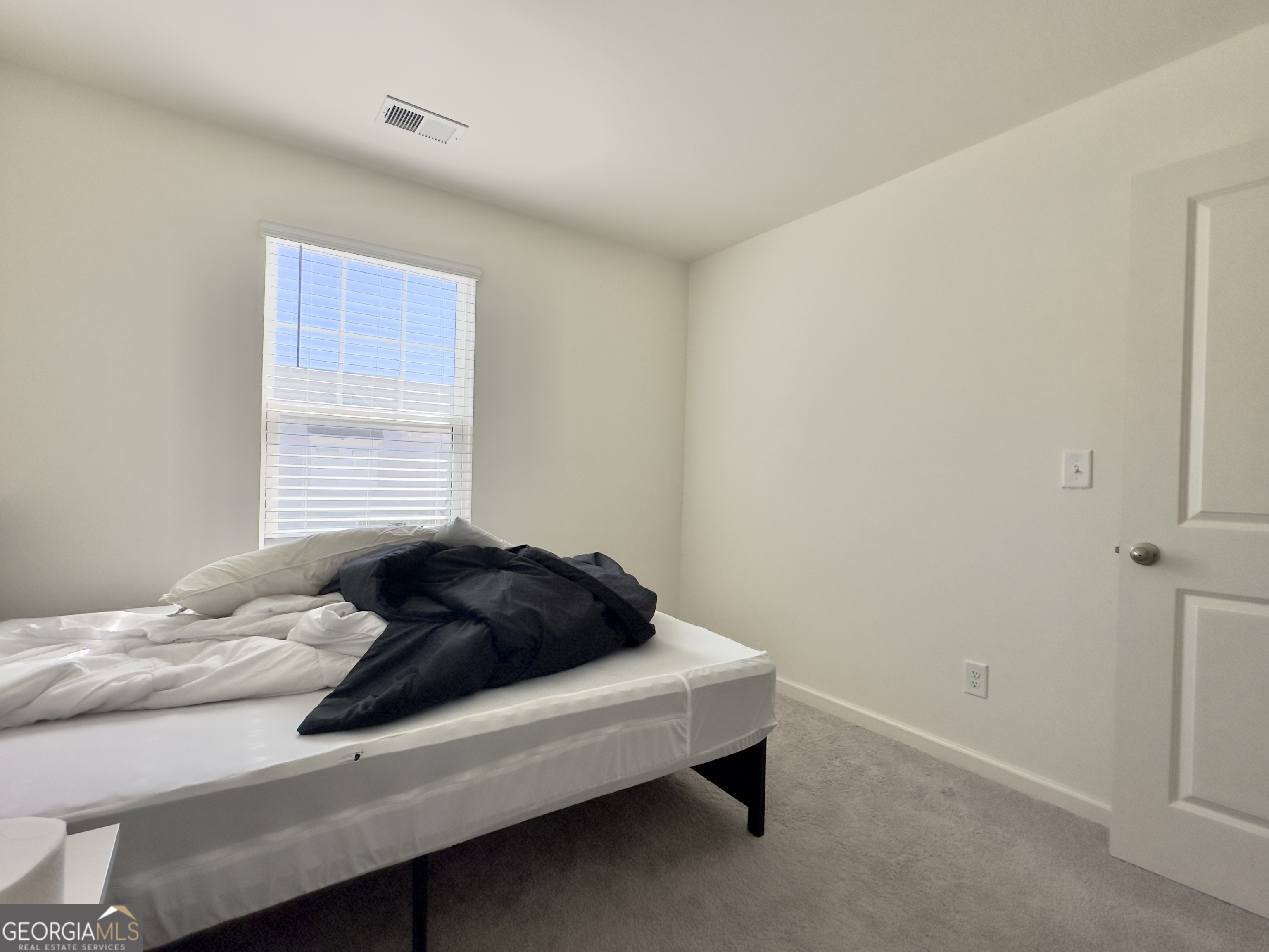105 Ellicott Way Cartersville, GA 30120 - Photo 17 of 24 a cat sitting on a bed in a room
