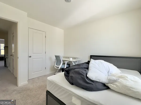 a bedroom with a bed and furniture