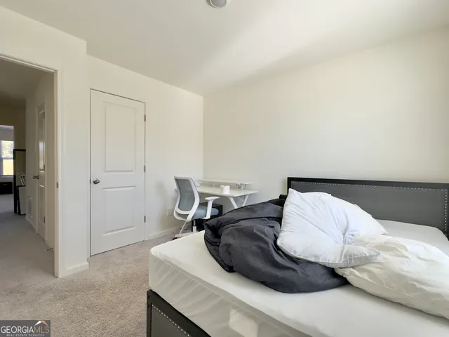 a bedroom with a bed and furniture