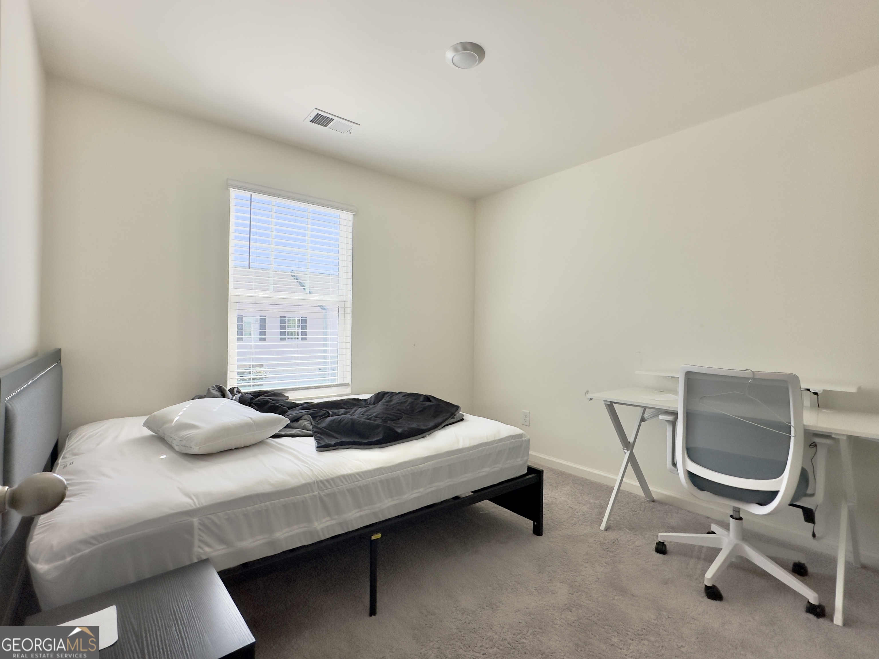 105 Ellicott Way Cartersville, GA 30120 - Photo 19 of 24 a bedroom with a bed and a chair