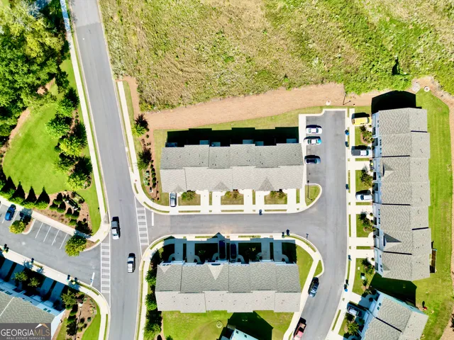 a living room with furniture a wooden floor and a flat screen tv