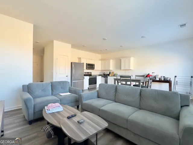 a bedroom with two beds and a couch