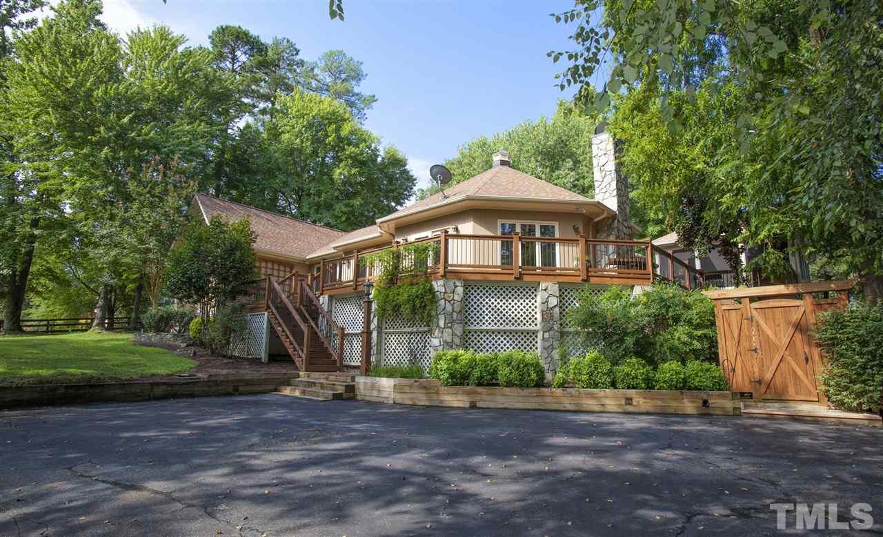 3529 Old Milburnie Road Raleigh, NC 27616 - Photo 2 of 25 a front view of a house with a yard and trees