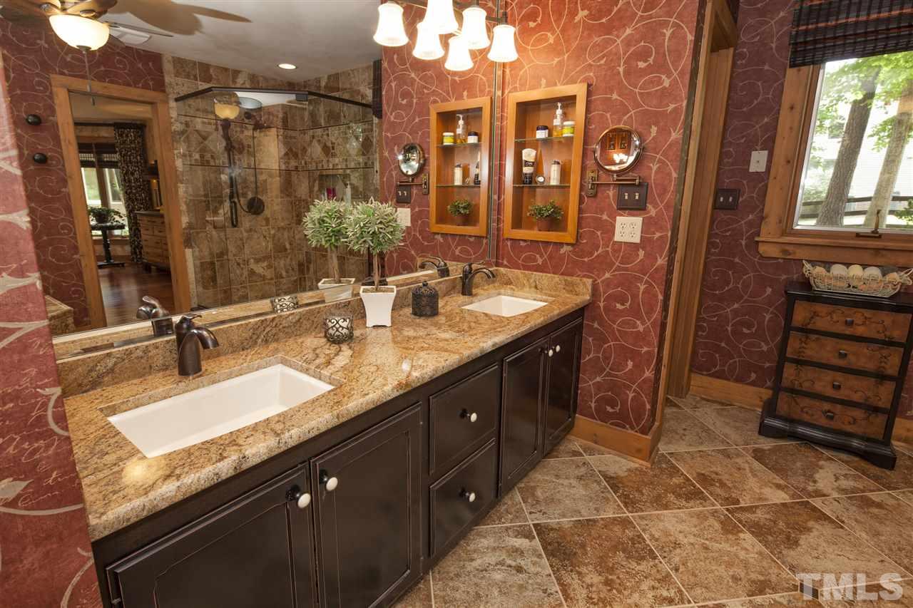 3529 Old Milburnie Road Raleigh, NC 27616 - Photo 12 of 25 a bathroom with a double vanity sink and a mirror
