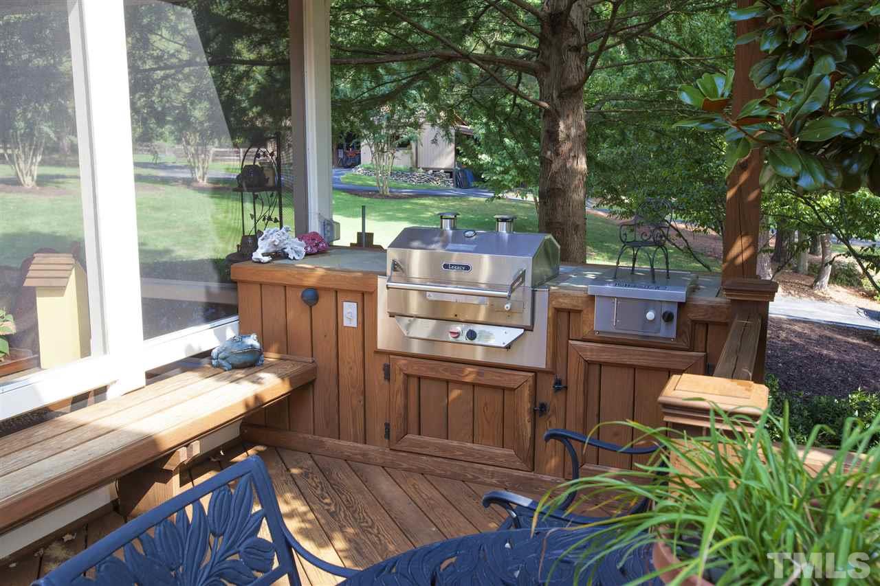 3529 Old Milburnie Road Raleigh, NC 27616 - Photo 20 of 25 a view of a patio with table and chairs potted plants and a large tree
