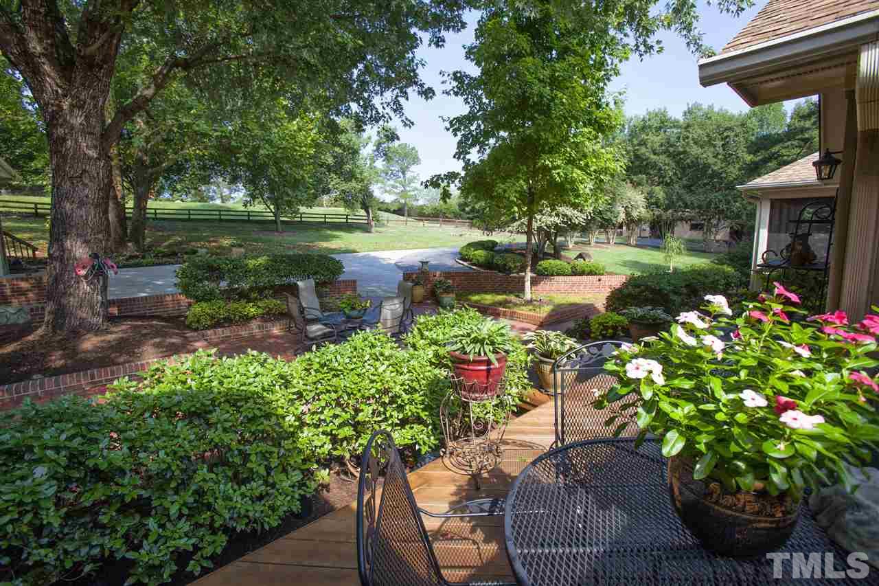 3529 Old Milburnie Road Raleigh, NC 27616 - Photo 4 of 25 a view of a garden with a fountain
