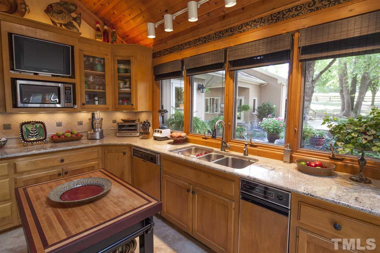 3529 Old Milburnie Road Raleigh, NC 27616 - Photo 8 of 25 a kitchen with a sink and large windows