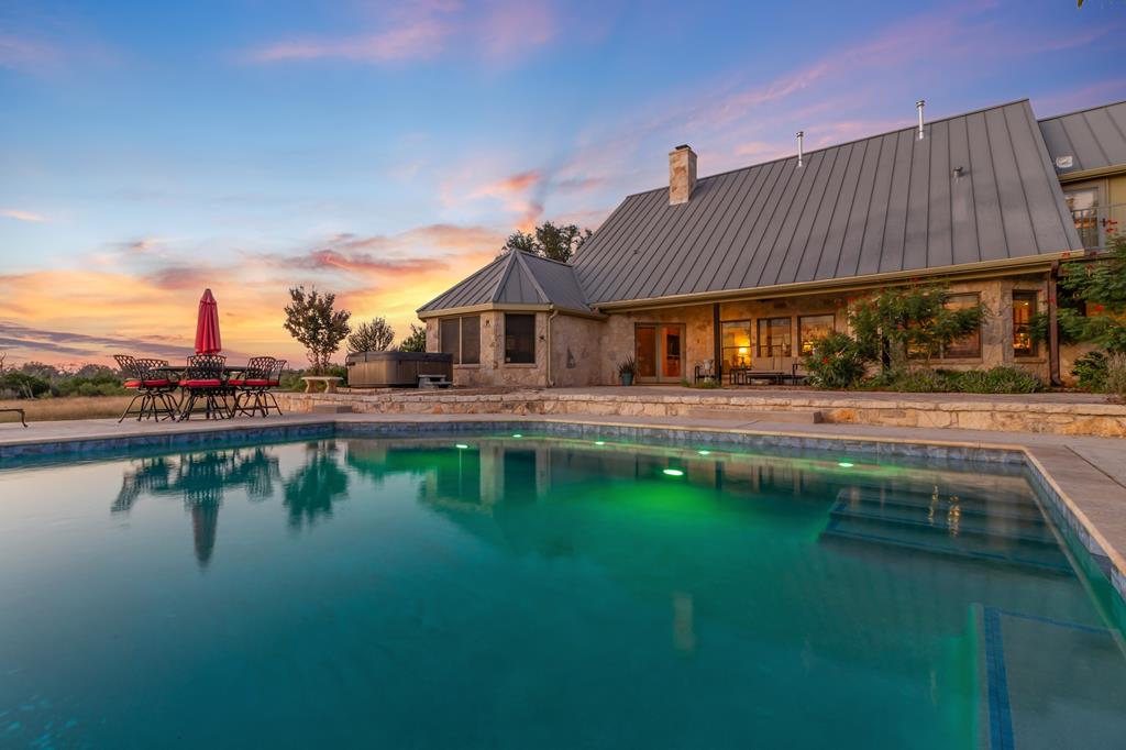a swimming pool view with a outdoor seating space