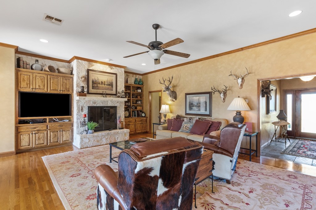 647 Funf Kinder Road Fredericksburg, TX 78624 - Photo 31 of 100 a living room with furniture a flat screen tv and a fireplace