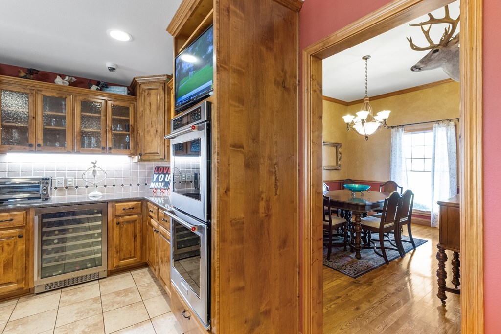 647 Funf Kinder Road Fredericksburg, TX 78624 - Photo 39 of 100 a kitchen with stainless steel appliances granite countertop a stove and a sink